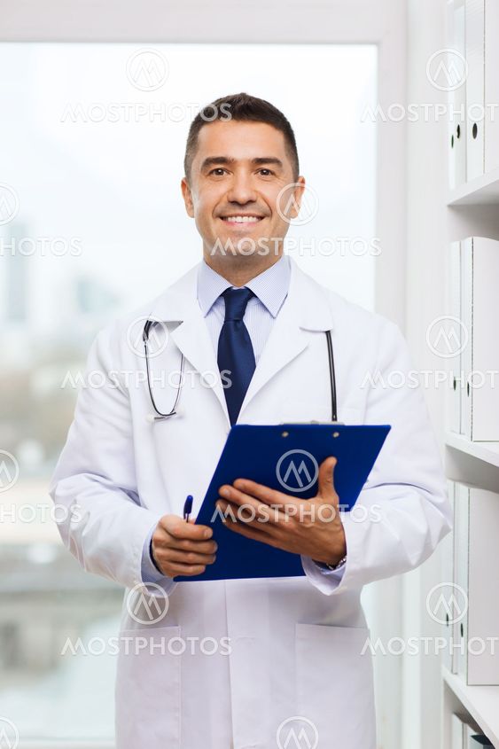 happy doctor with clipboard in medical office