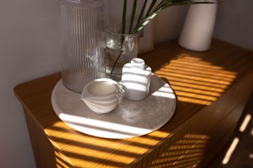 Ceramic tray on a wooden chest of drawers in the...