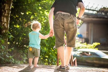 Dad walking with son in the sun