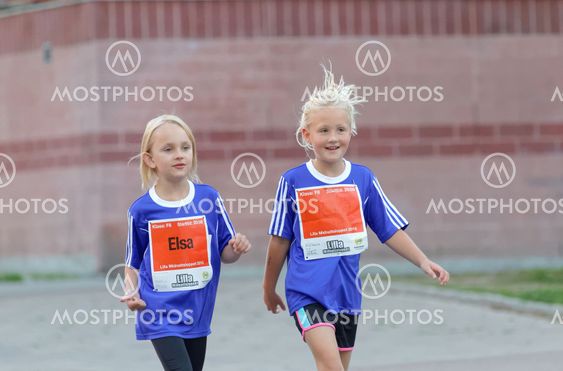 Two smiling girls walking