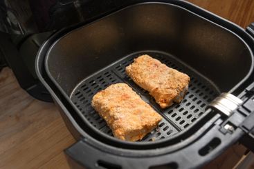 Breaded fish fillets of cod are prepared with low fat in...