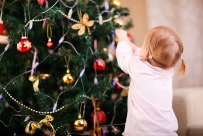 Little girl decorating Christmas tree