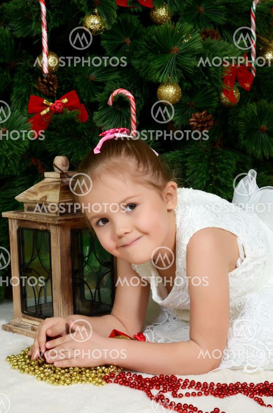 The little girl at christmas fur-tree