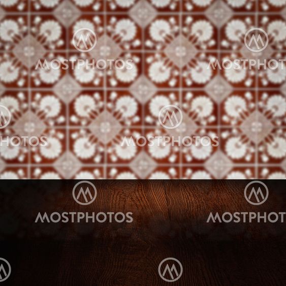 Wood table top and blur vintage ceramic tile pattern wall