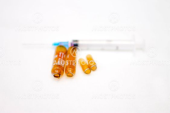 Empty medical ampoules infusion and used syringe after...