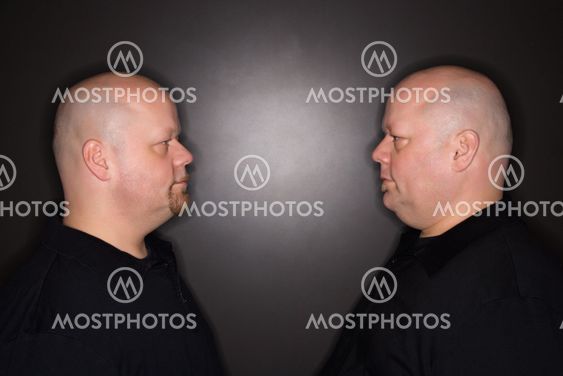 Twin men staring.