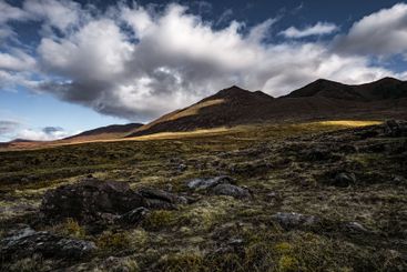 Dramatic landscape of hills under a dynamic sky at dusk...
