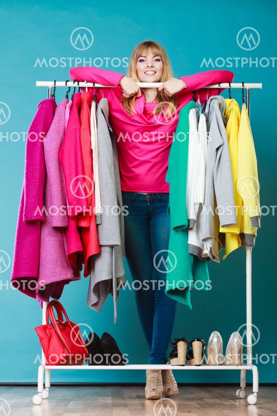Woman choosing clothes to wear in mall or wardrobe