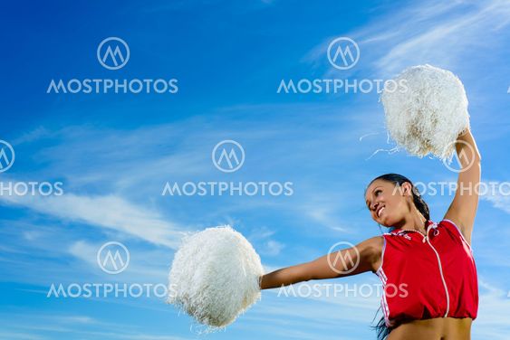 Young cheerleader in red costume with pampon