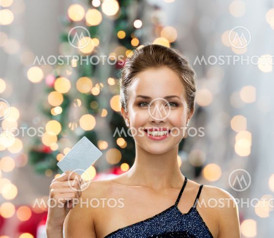 smiling woman in evening dress holding credit card