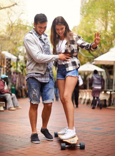 Skateboard ride, happy and couple teaching girlfriend...