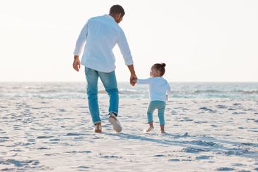 Dad, beach or holding hands with toddler for walk,...