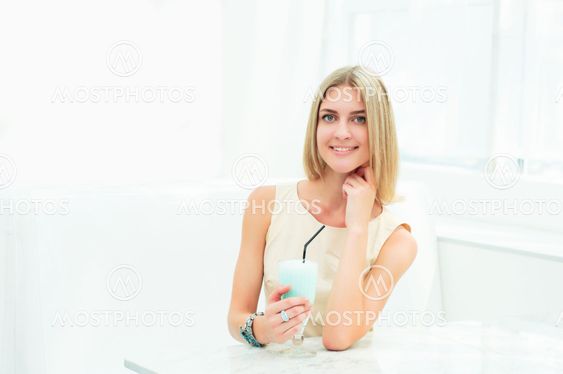 Portrait of a cute woman in a city cafe