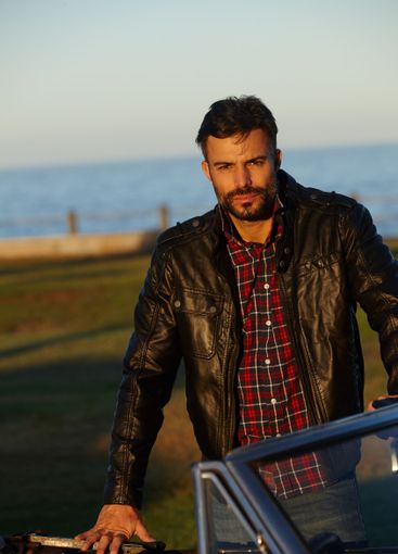 Portrait, confident or man by car at sea for solo...