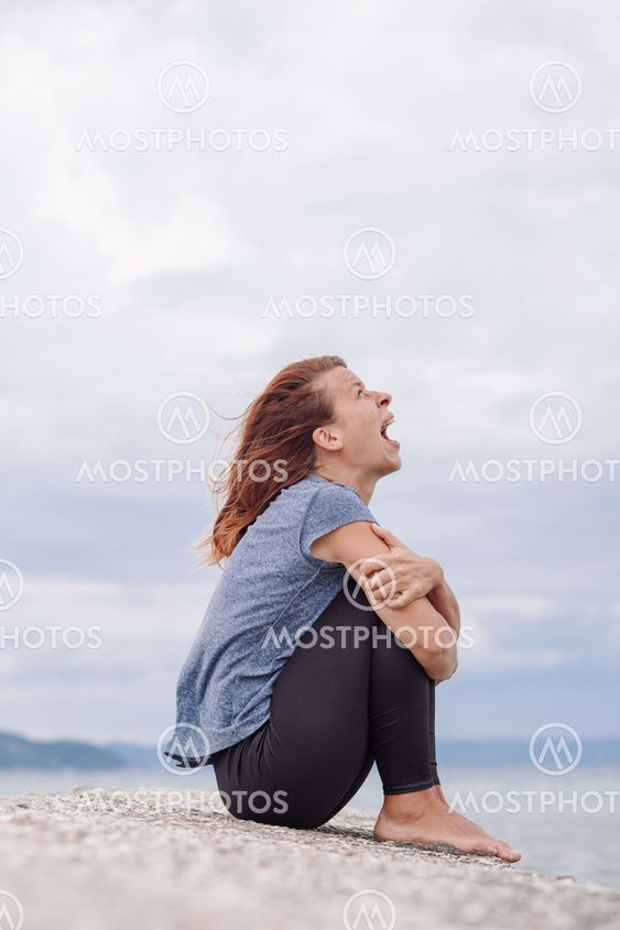 Woman alone and depressed screaming on the bridge
