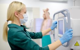 Female radiologist is making an Xray of lungs of patient...