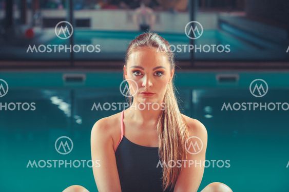 Sporty fit woman in swimming pool.