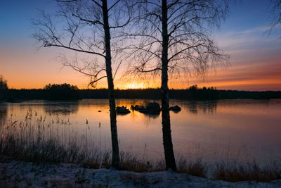 Sunset over frozen lake