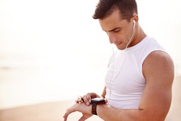 Sports, beach and man with smart watch for tracking...