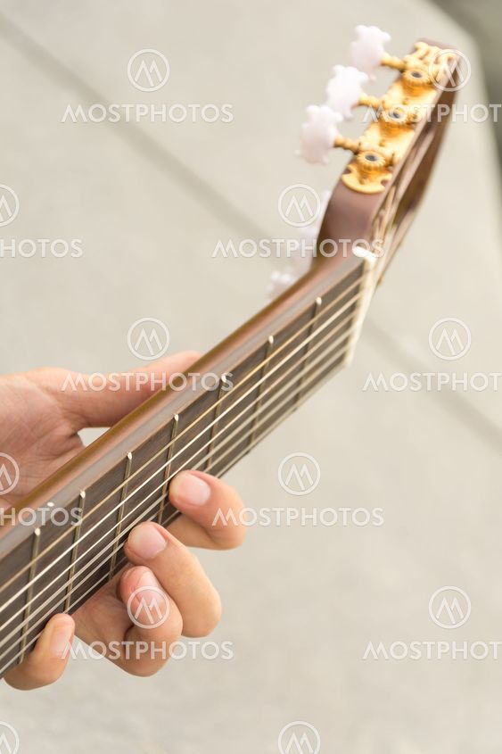 hand playing on guitar