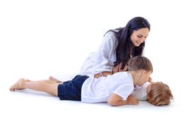 Young mother and her two little boys. Woman in casual...