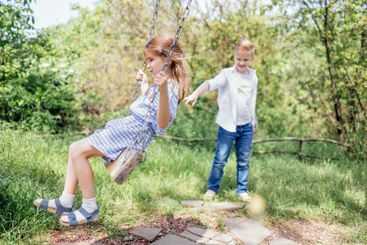 Pretty schoolboy in jeans and white shirt is rocking his...