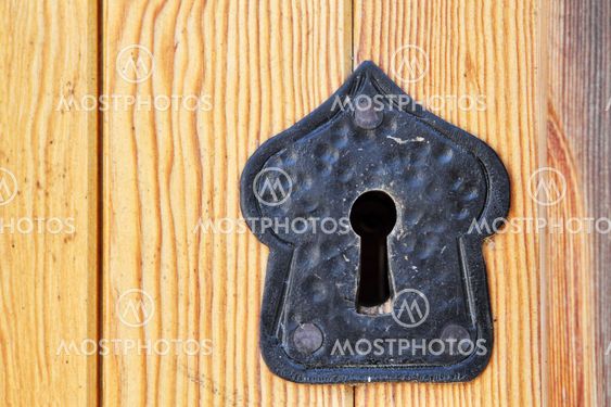 old black keyhole on wooden door