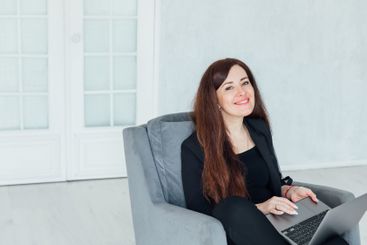 woman brunette sitting on chair online laptop