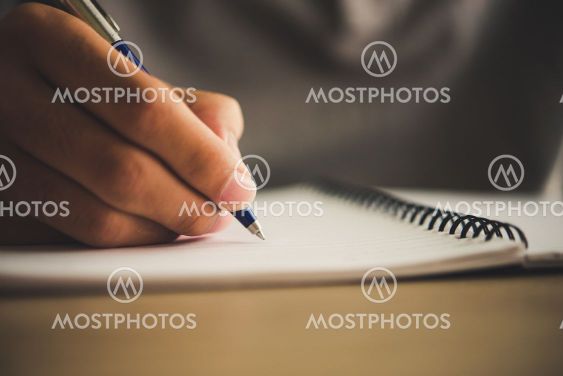 Man hand with pen writing on notebook.