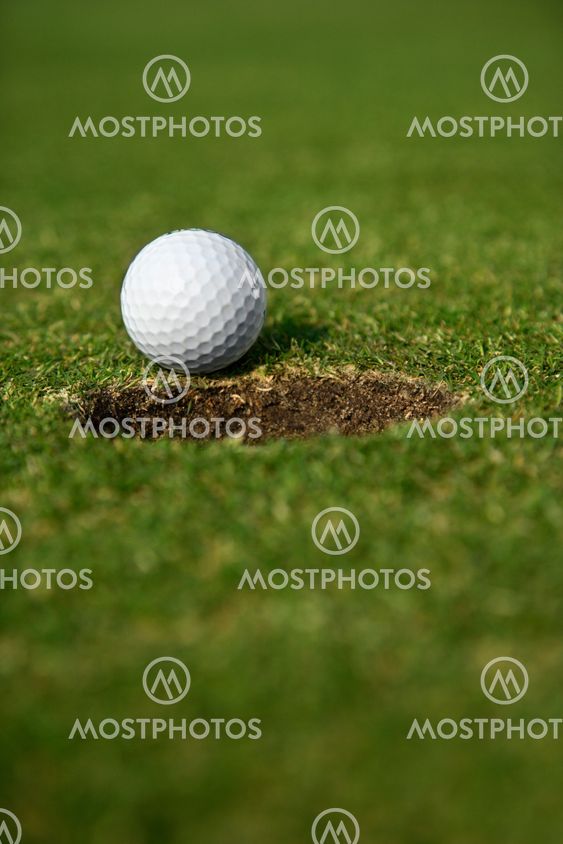 Golf ball by hole.