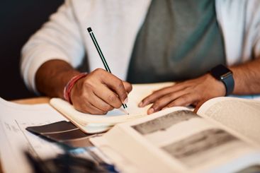 Hands, writing and man in university studying for civil...