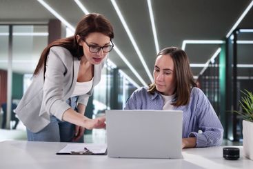 Busy Business Woman Leading Meeting with Colleagues