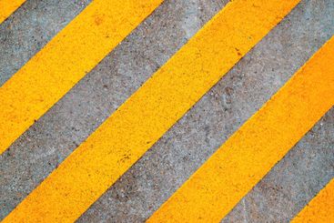 Yellow stripe pattern as reserved space on concrete road...