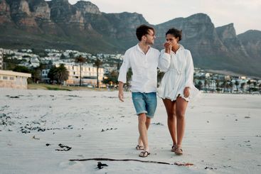 Walking, holding hands and couple kiss at beach for...