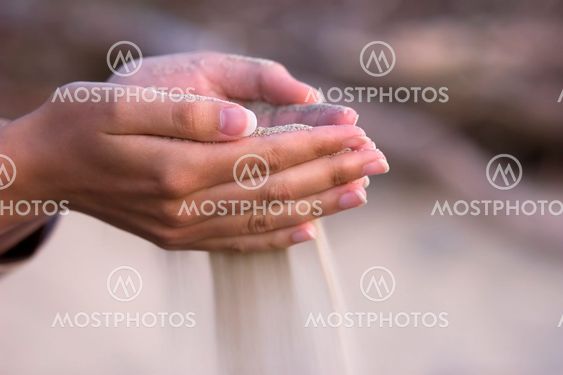 pouring sand from hands