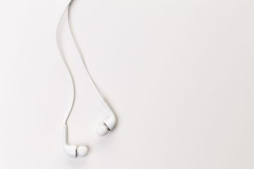 Pair of earphones close up on grey background