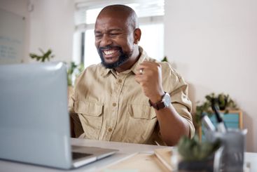 Black man, laptop and online winner to celebrate in home...