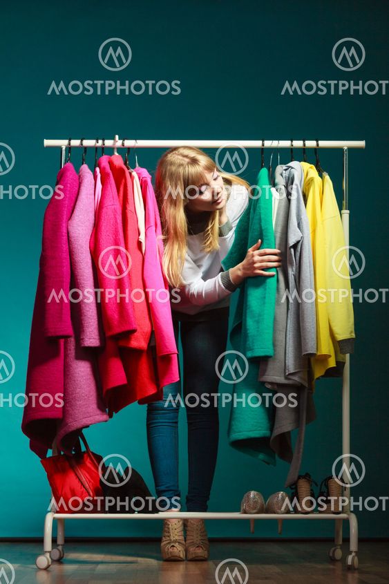 Woman choosing clothes to wear in mall or wardrobe