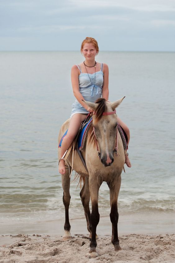 Girl rides on horse