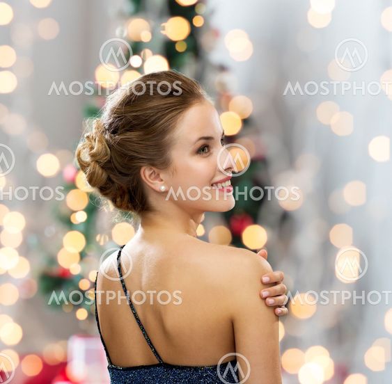 smiling woman in evening dress wearing earrings