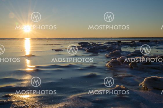 Sunshine at an icy winter coast