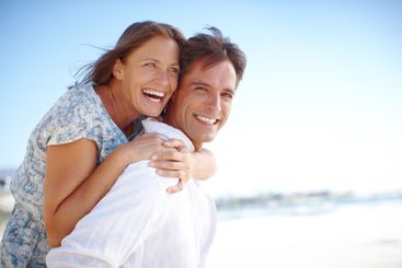 Laughing, hug and couple with joy, outdoor and holiday...