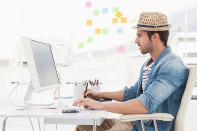 Casual designer using computer and digitizer