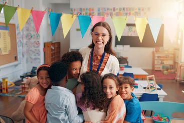 Happy, portrait and children hugging teacher in...