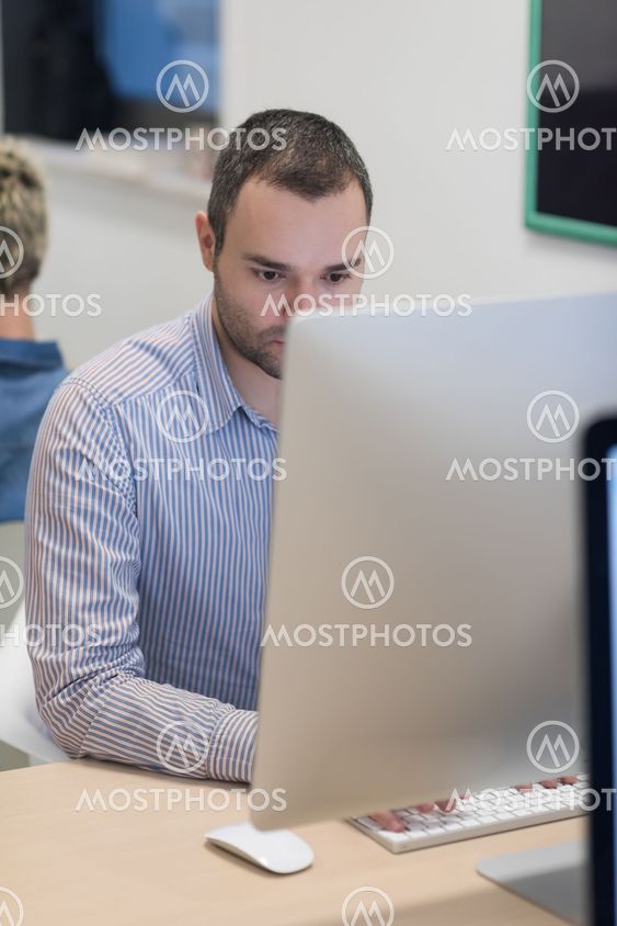 startup business, software developer working on desktop computer