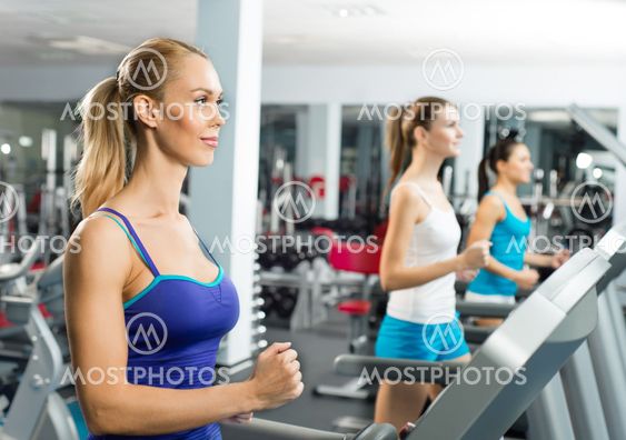 young women running on a treadmill