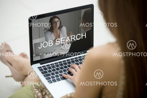 Woman sitting on sofa with laptop, trying to find job.