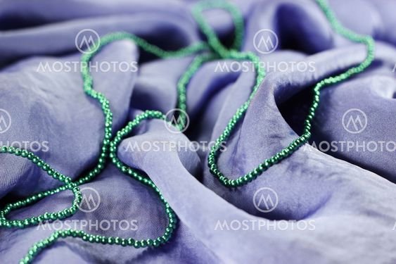 Texture of violet silk fabric with beads