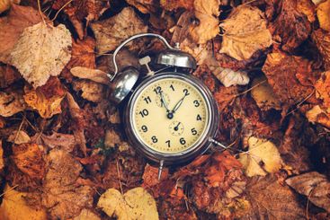 Daylight saving time concept, old analog alarm clock set...