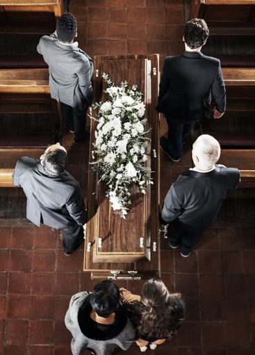 Funeral, coffin and family mourning death of loved one,...